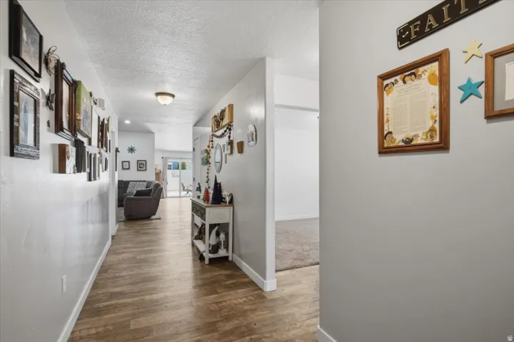 Spacious hallway featuring wood-finish flooring and neutral wall tones