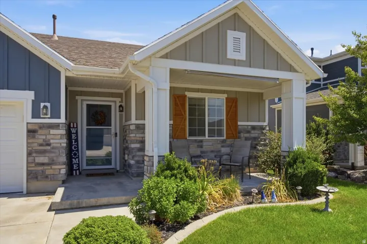 Craftsman-style exterior featuring stacked stone accents and vertical siding