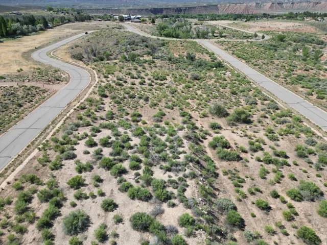 Paved roads traversing natural topography with scattered green foliage