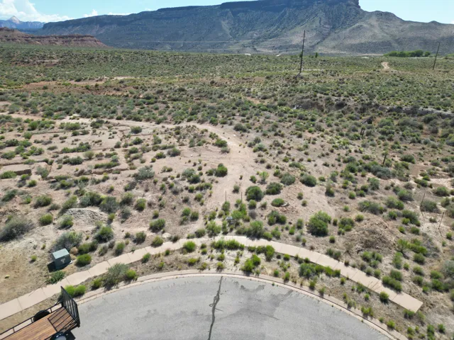 Expansive undeveloped lot featuring natural desert landscaping and mountain backdrop