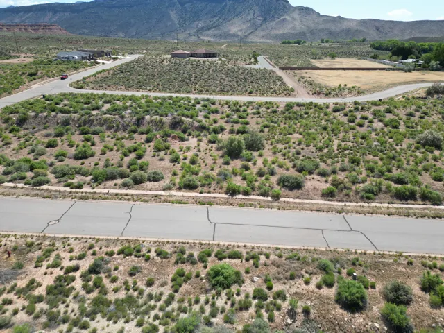 Mountainous landscape with undeveloped land, paved roads, and scattered residential properties