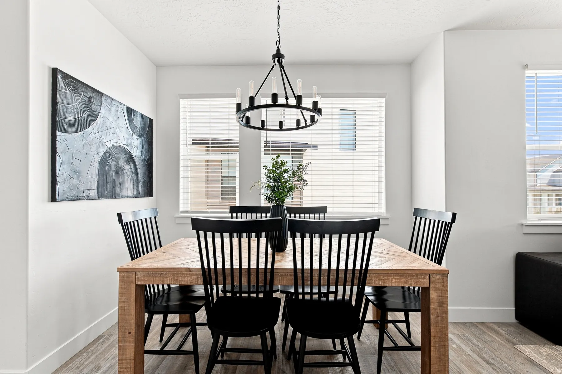 Recessed wall with large window, a second window, and a linear chandelier