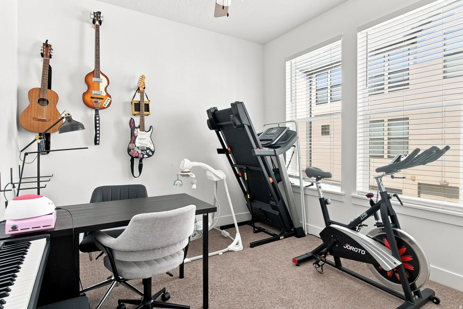 Bright, light-filled room with expansive windows offering natural light and urban outlooks