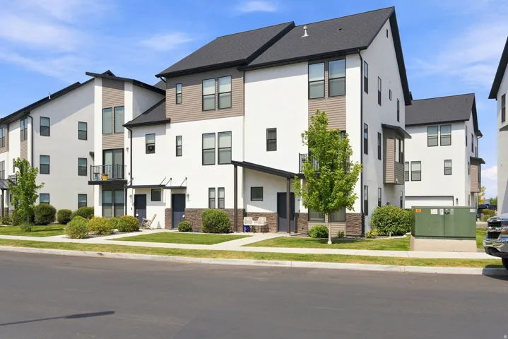 Contemporary multi-story exterior with white stucco and brown siding accents