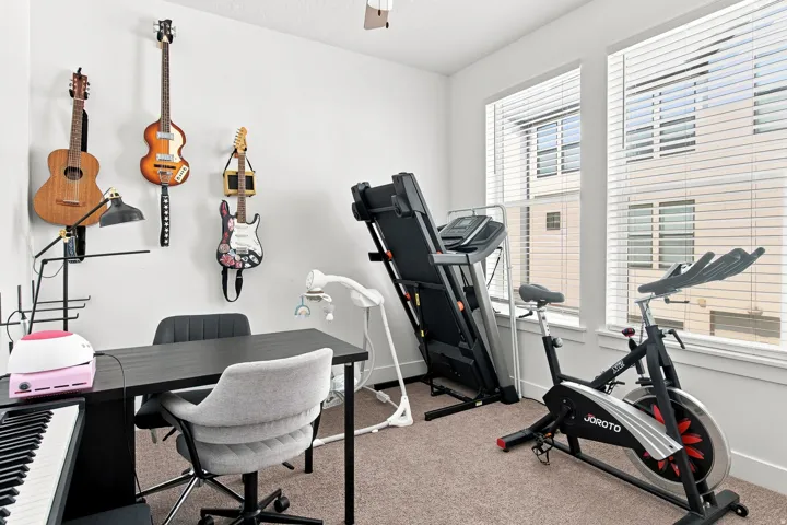 Bright, light-filled room with expansive windows offering natural light and urban outlooks