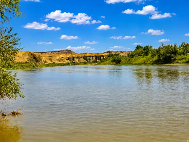 Riverfront property featuring expansive water frontage, natural bank, and distant bluffs
