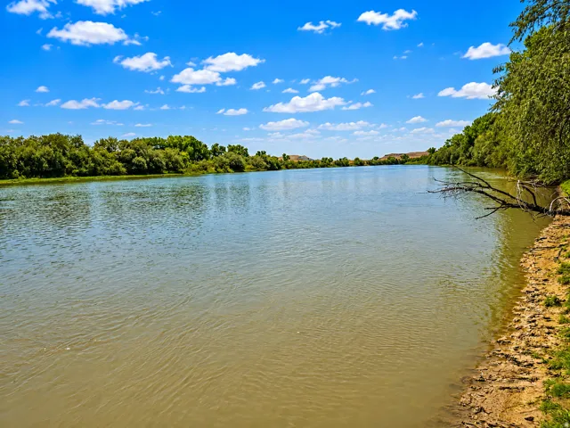 Expansive river frontage with mature trees along the banks
