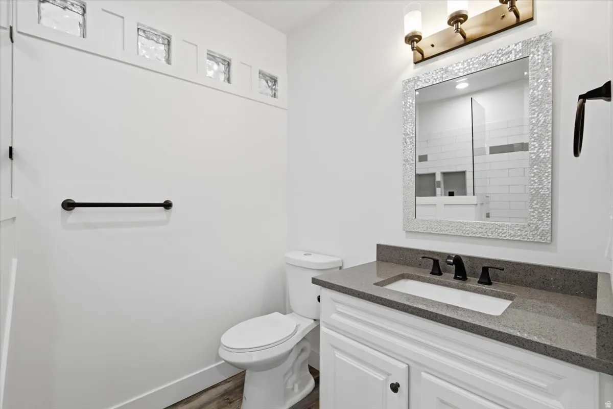 White vanity with black hardware, integrated sink, and gray countertop