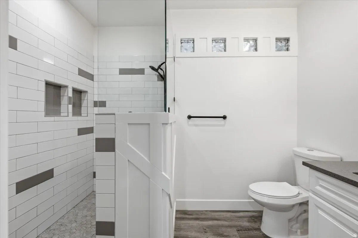 Shower with subway tile, built-in niches, and frameless glass enclosure