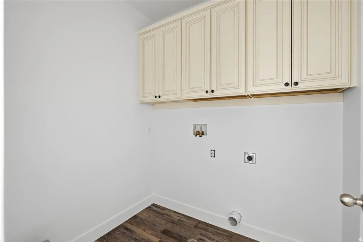 Wood-finish flooring with white baseboards and neutral wall paint