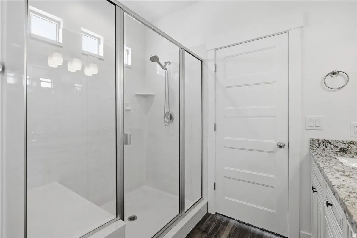 Glass-enclosed shower with a built-in bench, shower niche, and small transom windows
