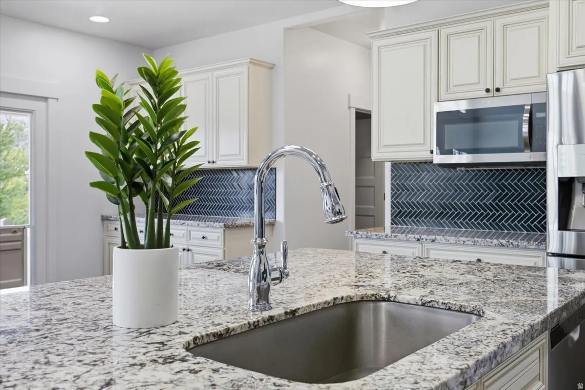 Stainless steel sink with a chrome gooseneck faucet