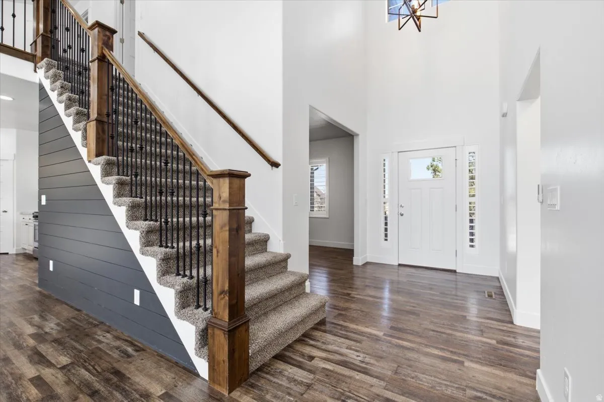 Two-story foyer with a vaulted ceiling and a decorative chandelier