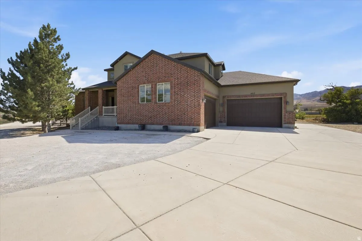 Brick and stucco exterior with multiple windows