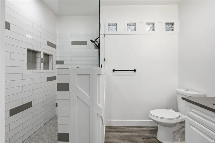 Shower with subway tile, built-in niches, and frameless glass enclosure