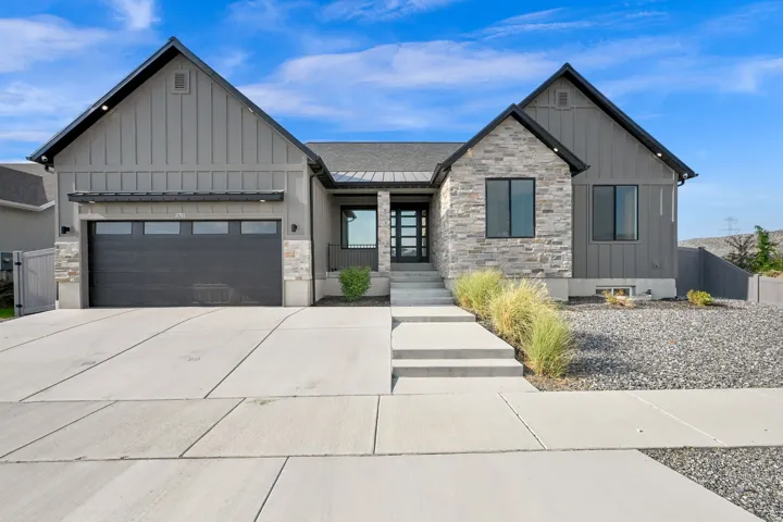 Contemporary exterior featuring board and batten siding and stone accents