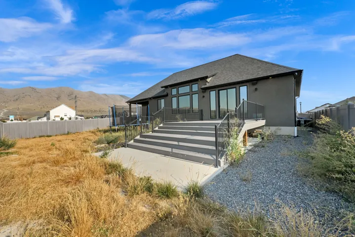 Modern exterior with a dark gray stucco finish and a dark shingle roof