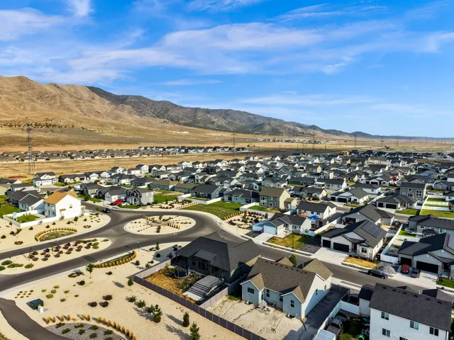 Expansive community featuring numerous single-family homes with mountain scenery backdrop