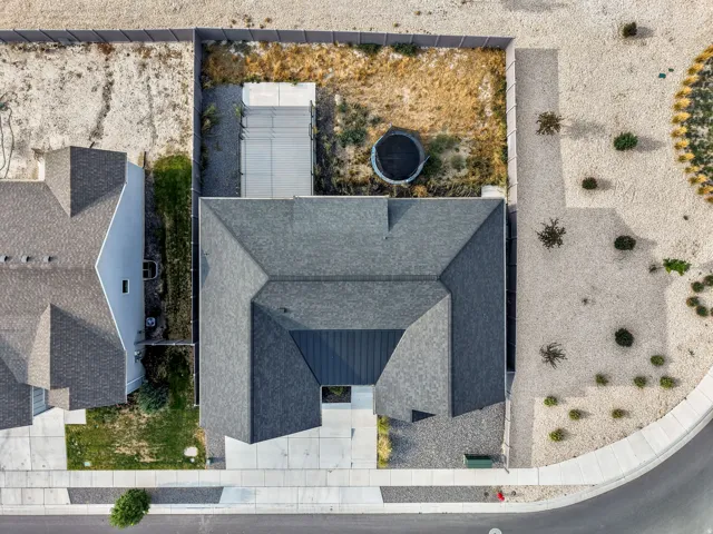 Shingle roof, concrete driveway, concrete sidewalk, perimeter fencing, gravel landscaping