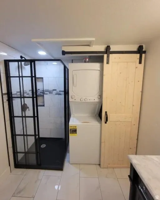 Glass-enclosed shower with black framing, integrated shower niche, and white tiled walls