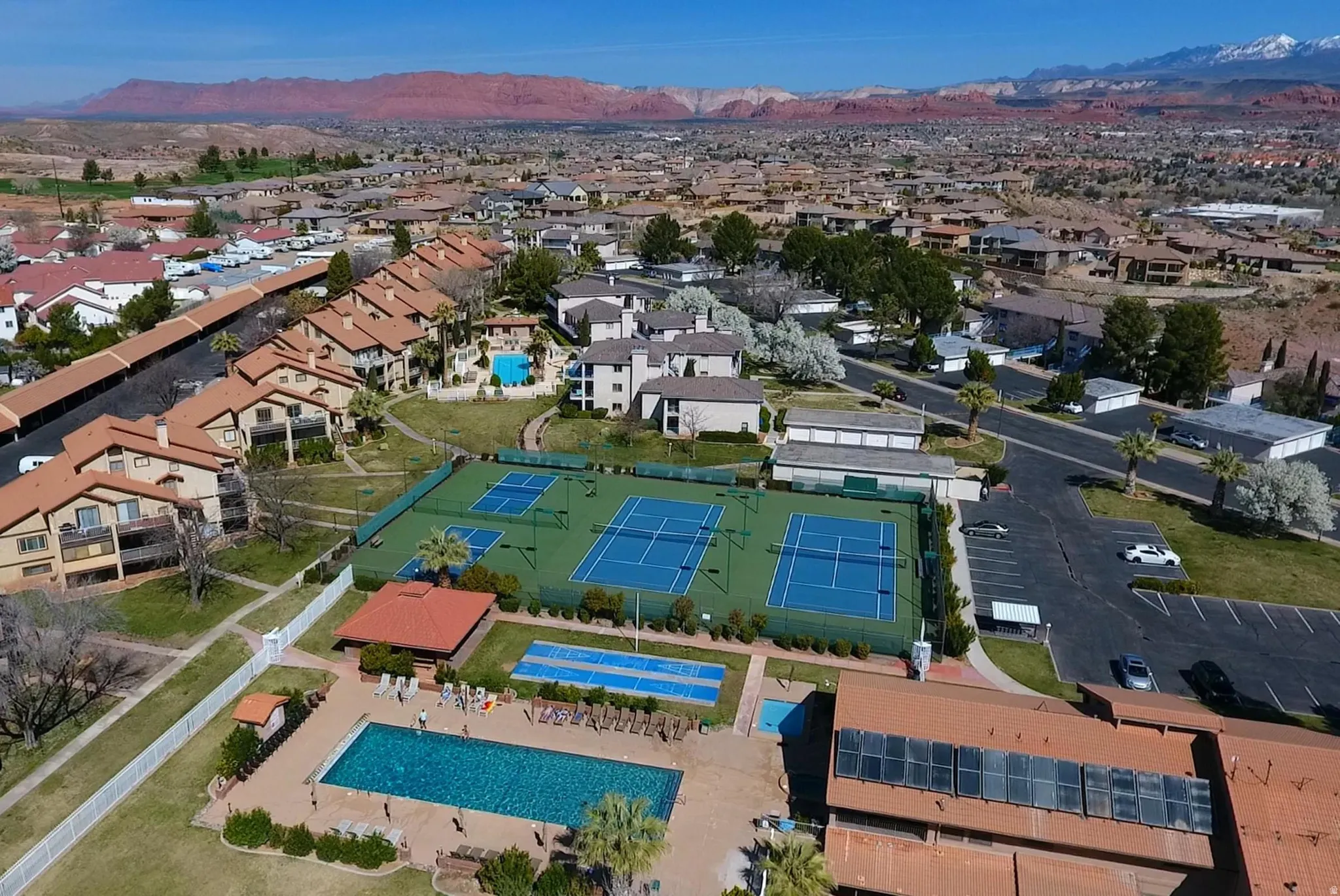 Community features multiple tennis courts, a large swimming pool, and a recreational building