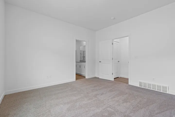 Recessed lighting, light-toned walls, and carpet flooring