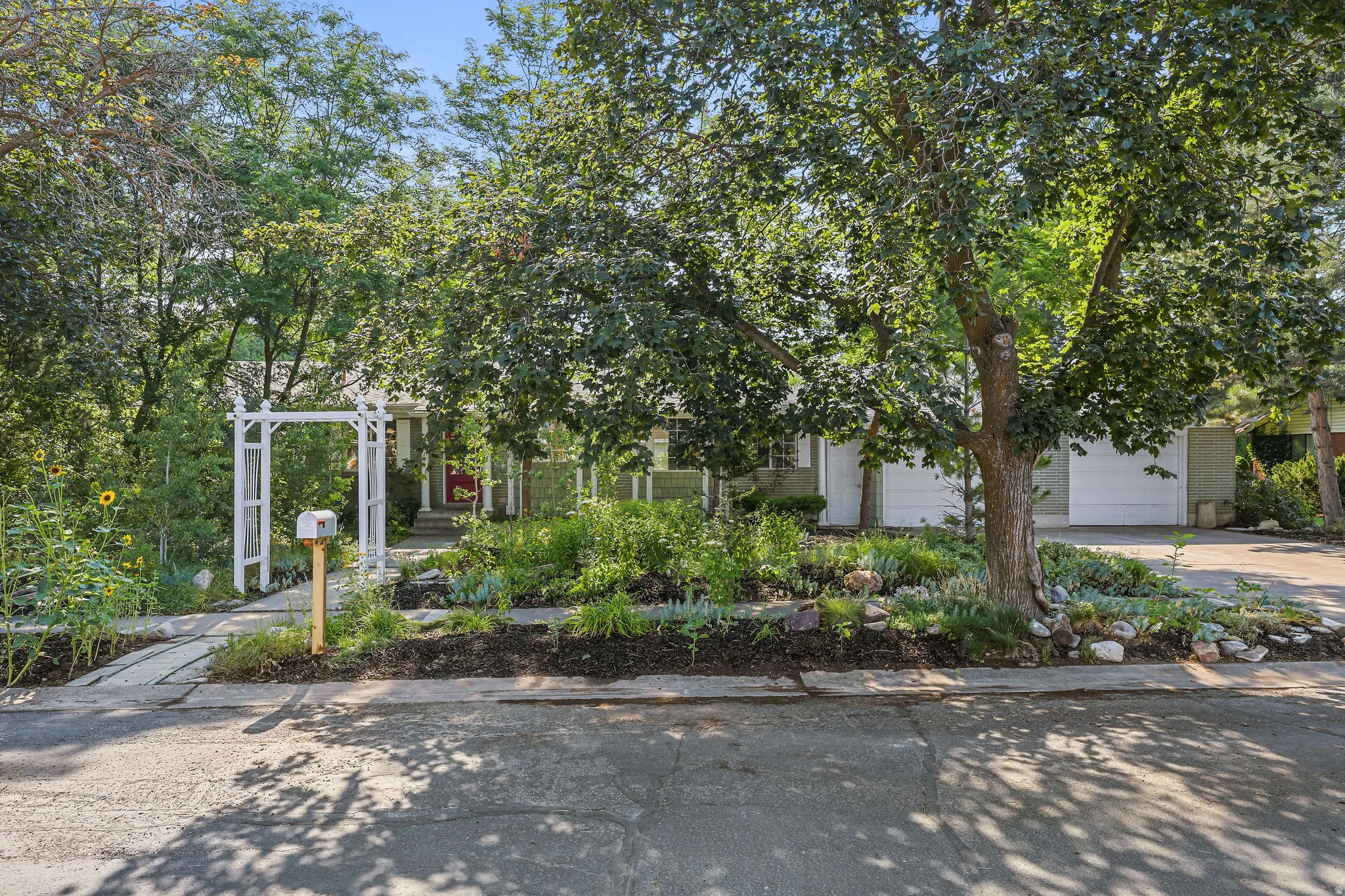 Single-story residence with a light-colored exterior and dual garage doors
