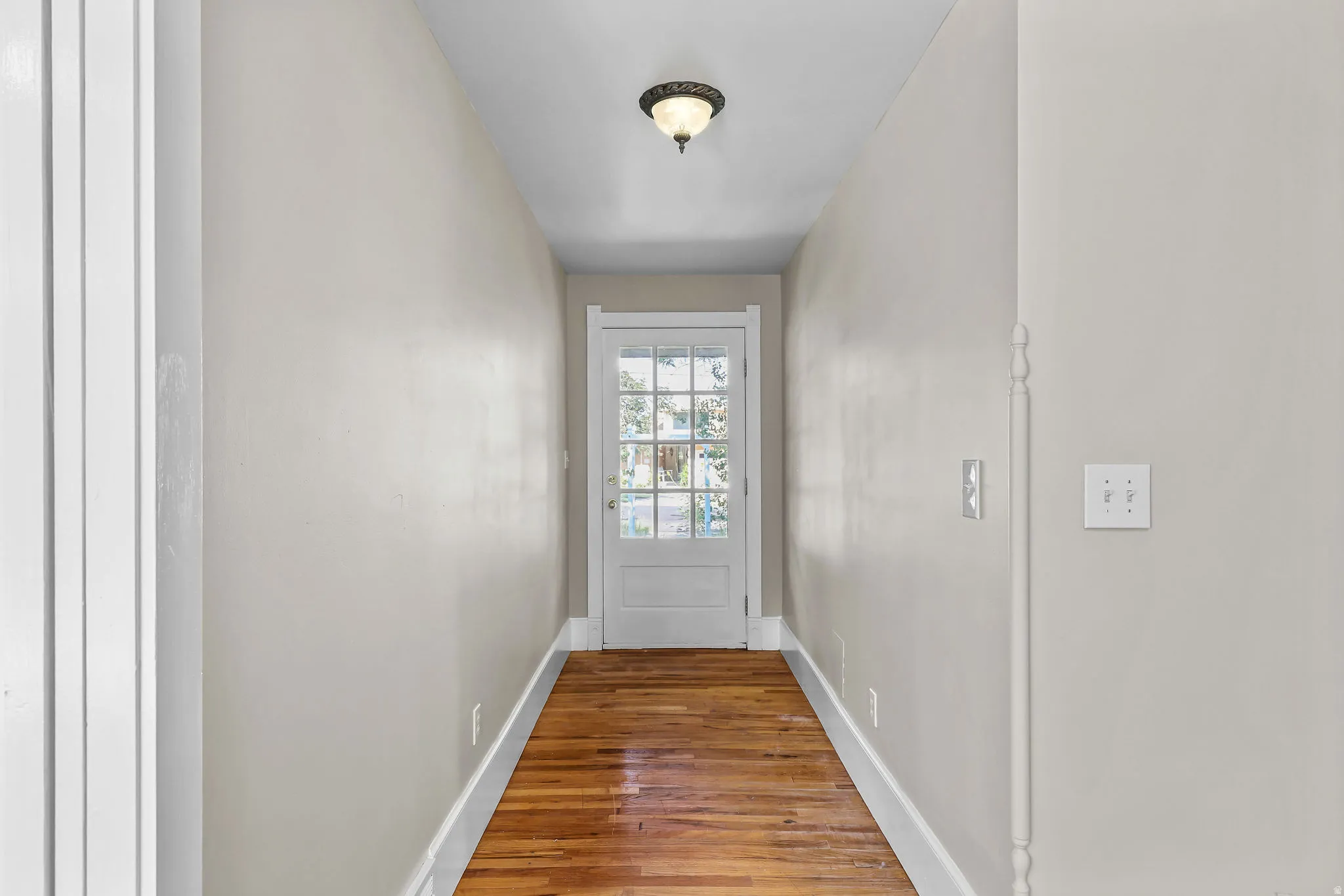 Hardwood flooring and light wall finishes complement the white trim