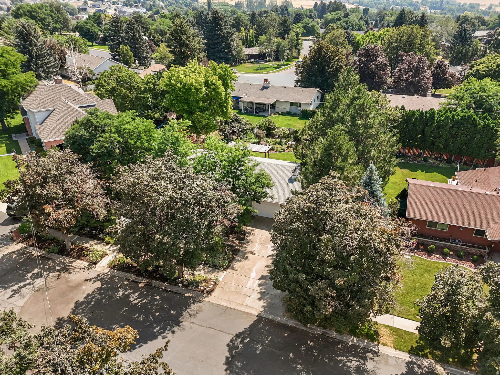 Mature landscaping with lush green lawn and established trees creates a serene setting