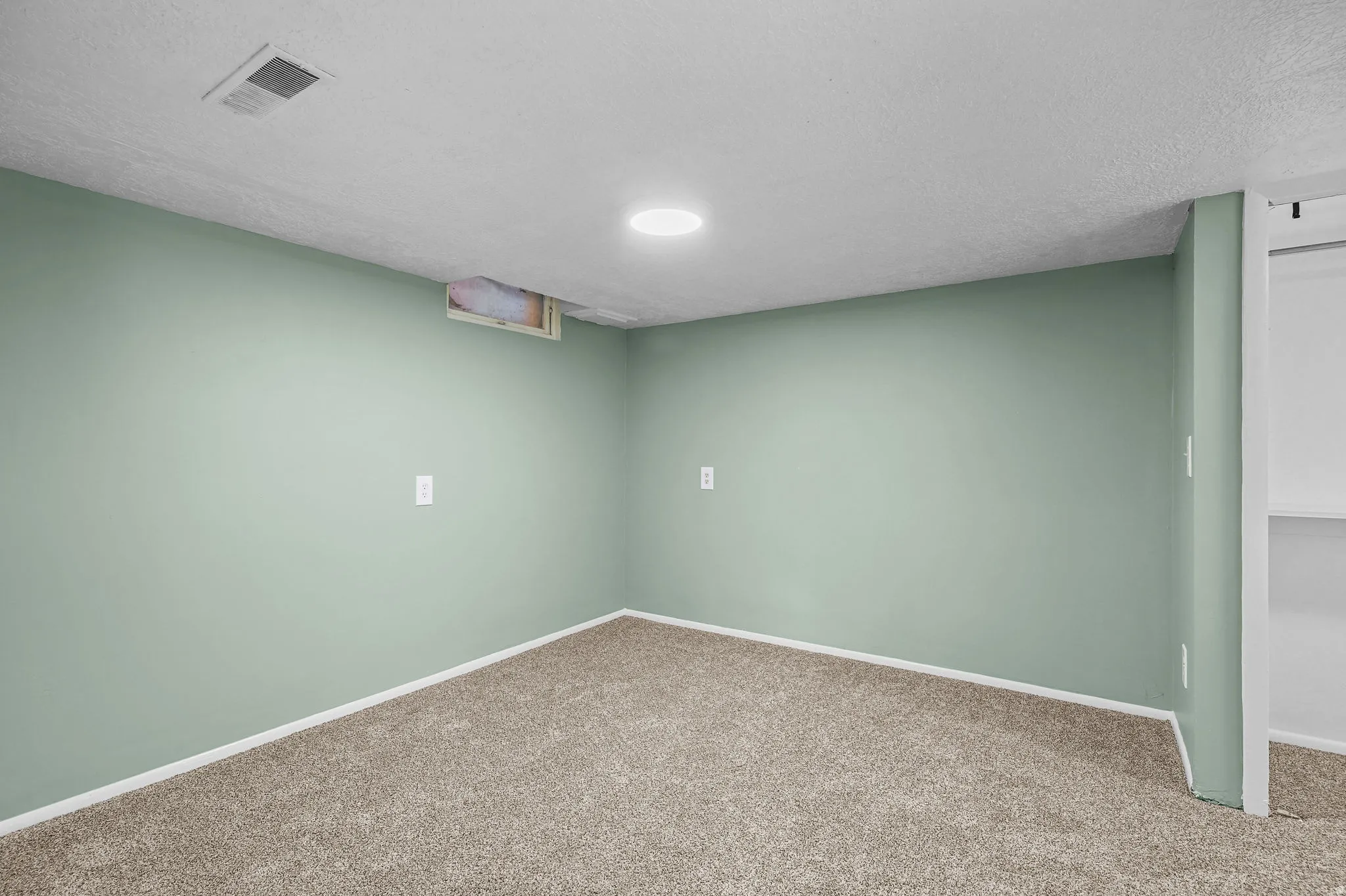 Wall-to-wall carpeting, recessed lighting, and light green painted walls