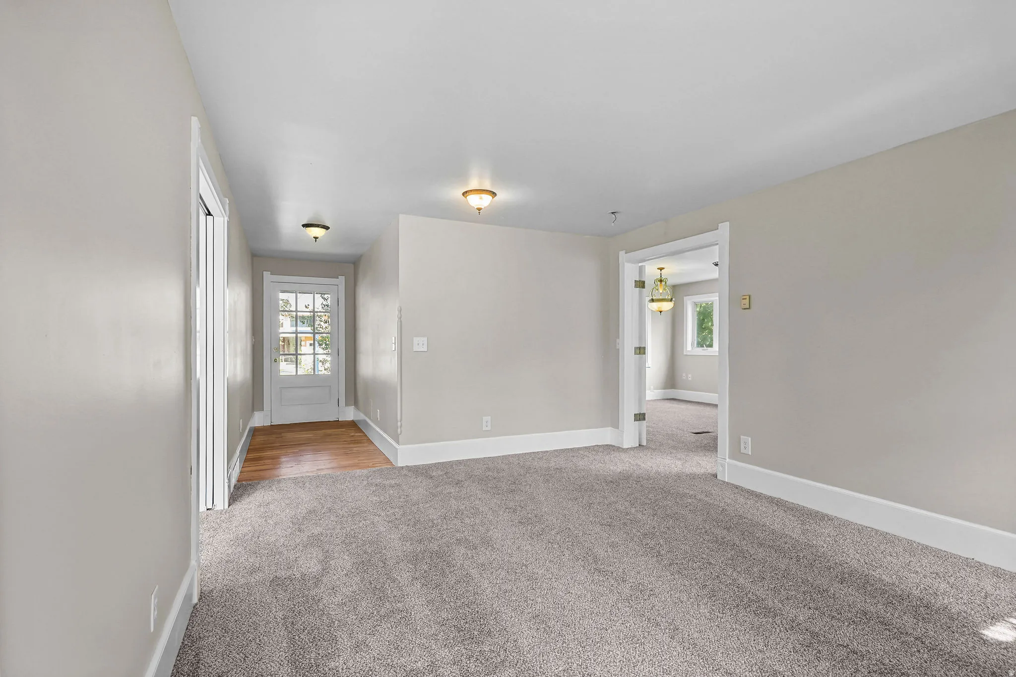 Neutral tone walls with white trim, recessed lighting, and a light wood-finish floor entryway