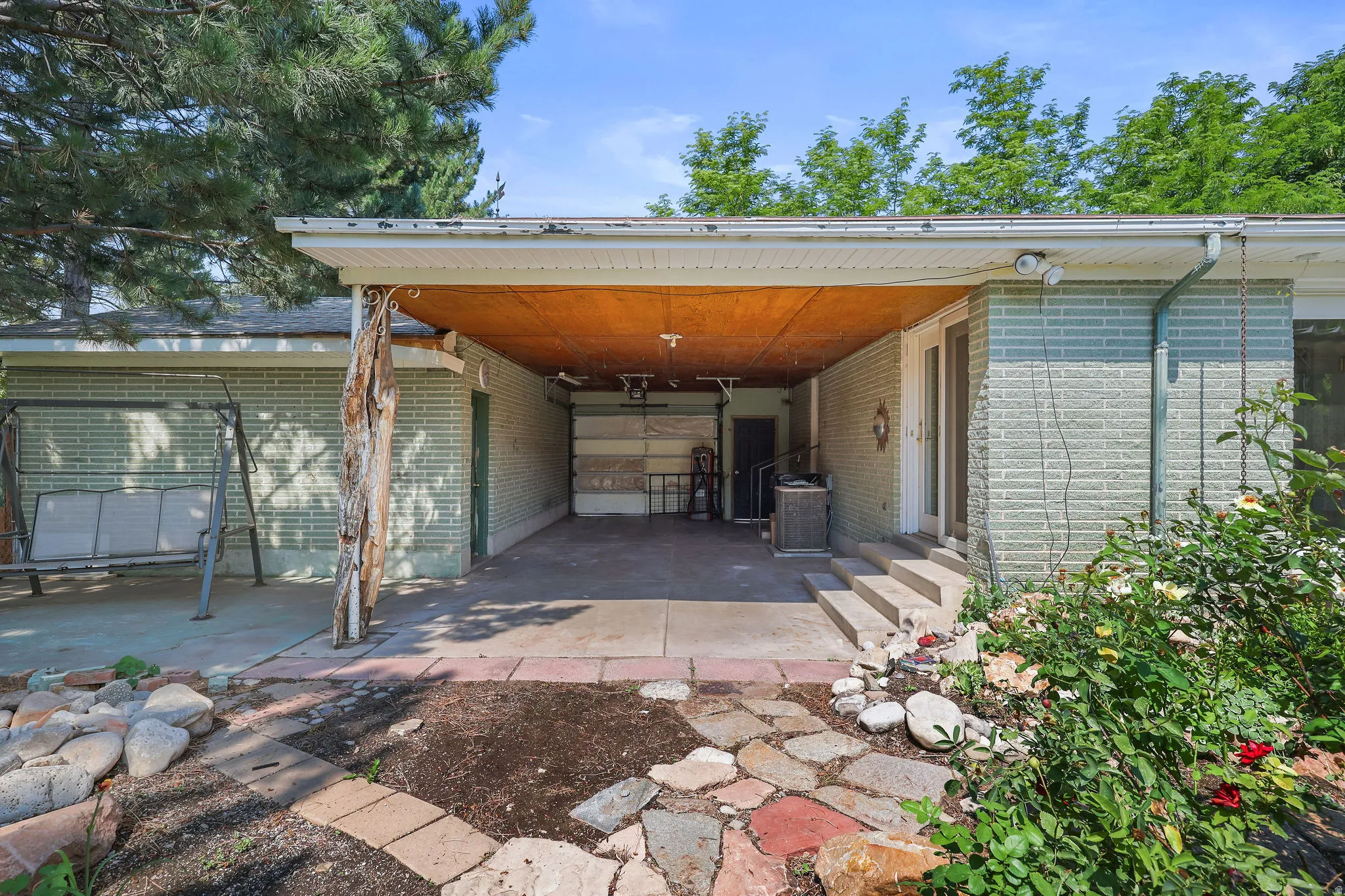 Covered carport with wood-finish ceiling