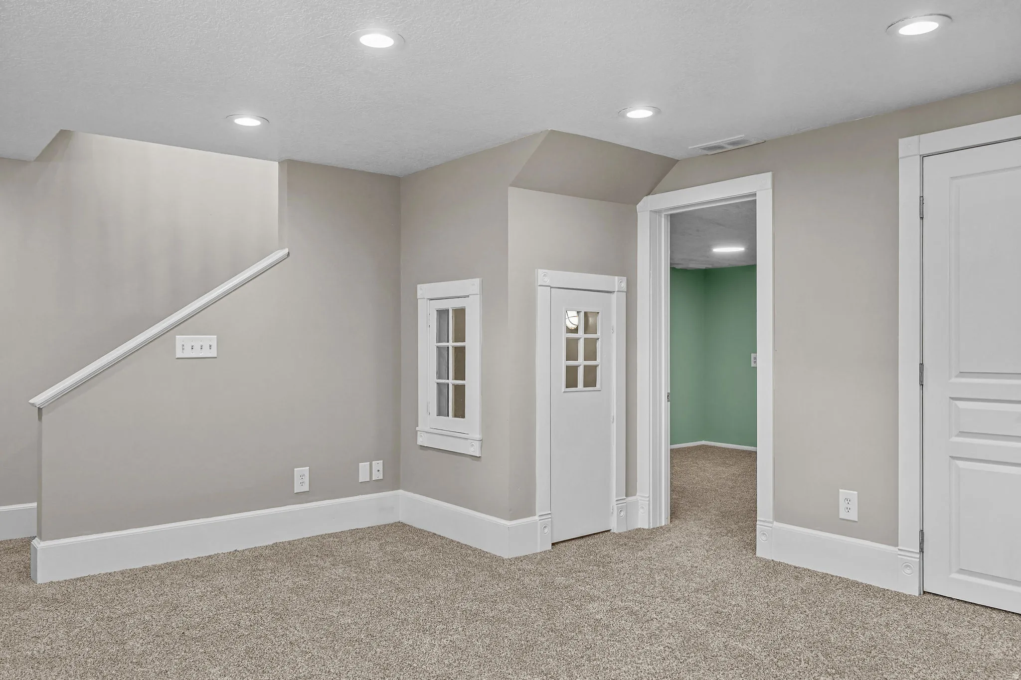 Recessed lighting illuminates a carpeted floor