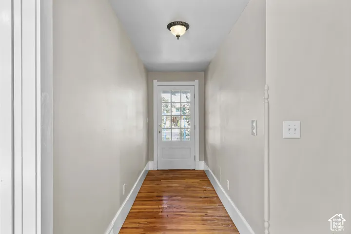 Hardwood flooring and light wall finishes complement the white trim