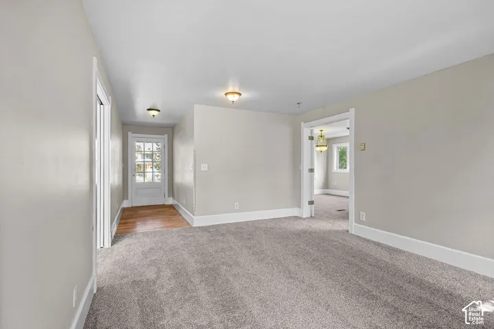 Neutral tone walls with white trim, recessed lighting, and a light wood-finish floor entryway