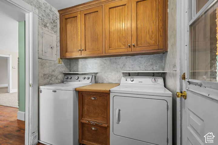 Laundry area with wood-finish upper cabinetry and a built-in wood-finish cabinet