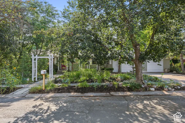 Single-story residence with a light-colored exterior and dual garage doors