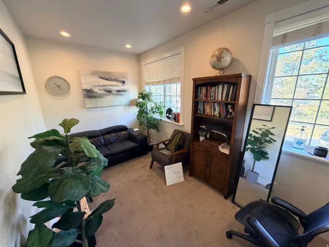 Carpeted interior room featuring recessed lighting and two large windows with blinds