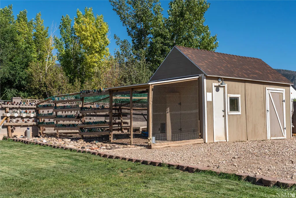 Charming rural property featuring a versatile outbuilding with covered lean-to shelter and fenced livestock enclosure