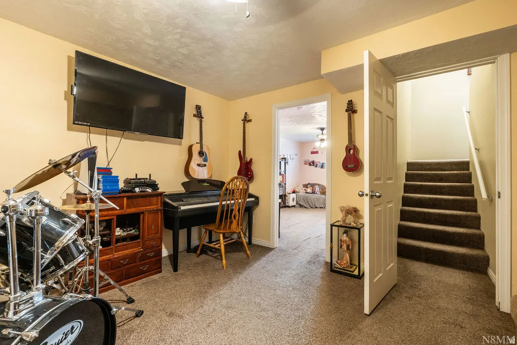 Carpeted flooring throughout, recessed lighting, and a neutral wall color