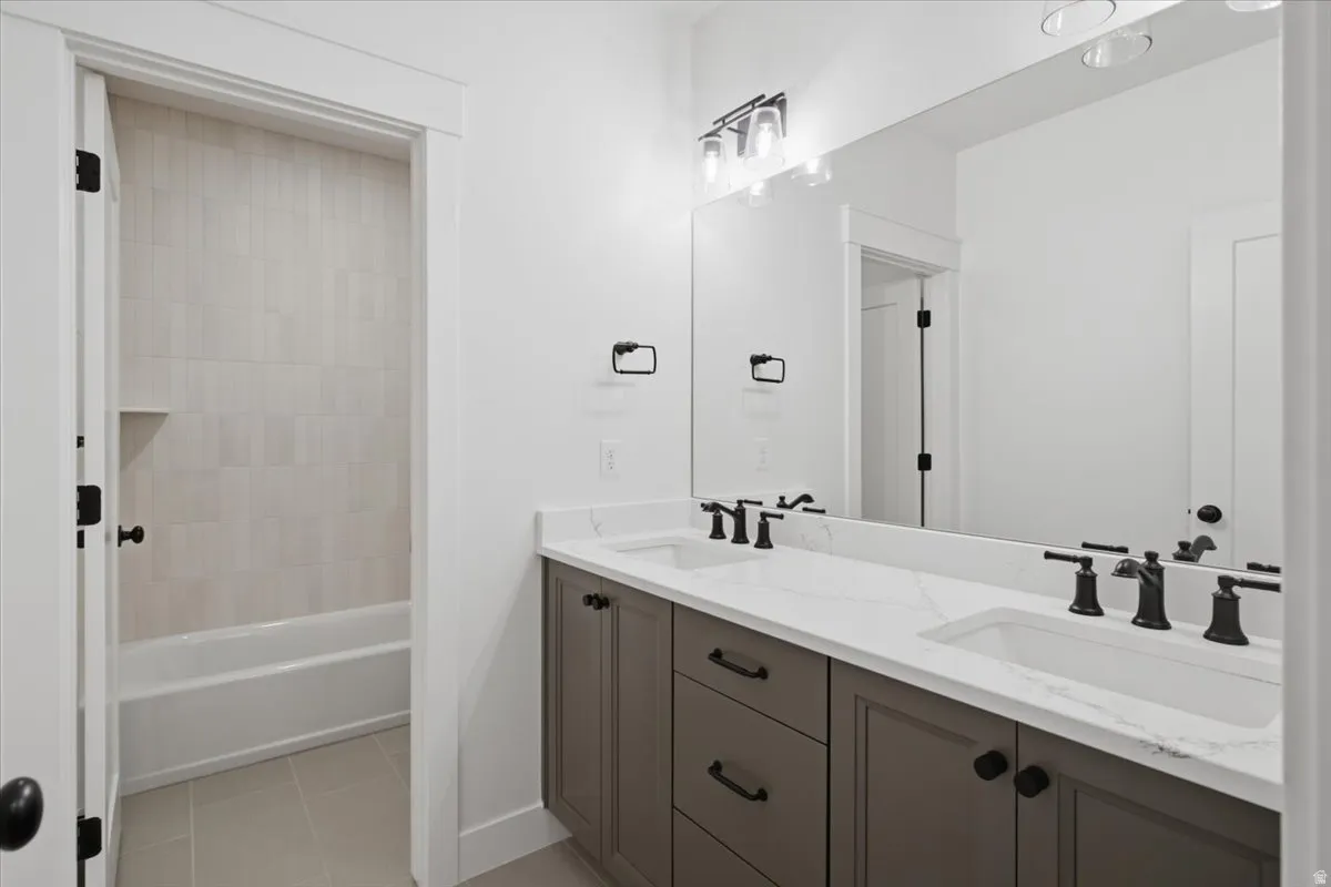 Dual vanity with white countertop, undermount sinks, and matte black fixtures