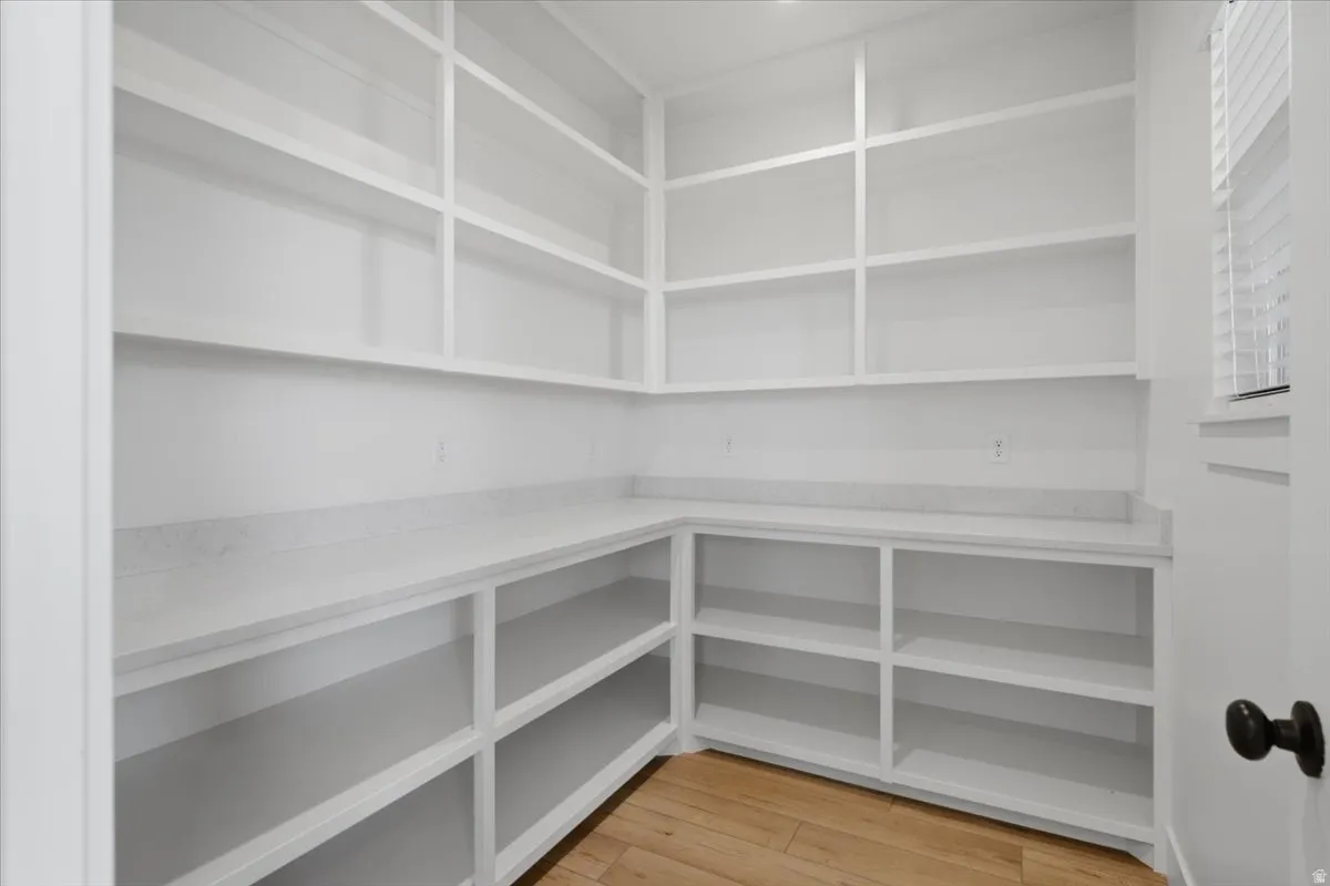 Custom built-in shelving, extensive counter space, hard-surface flooring, and a window with blinds