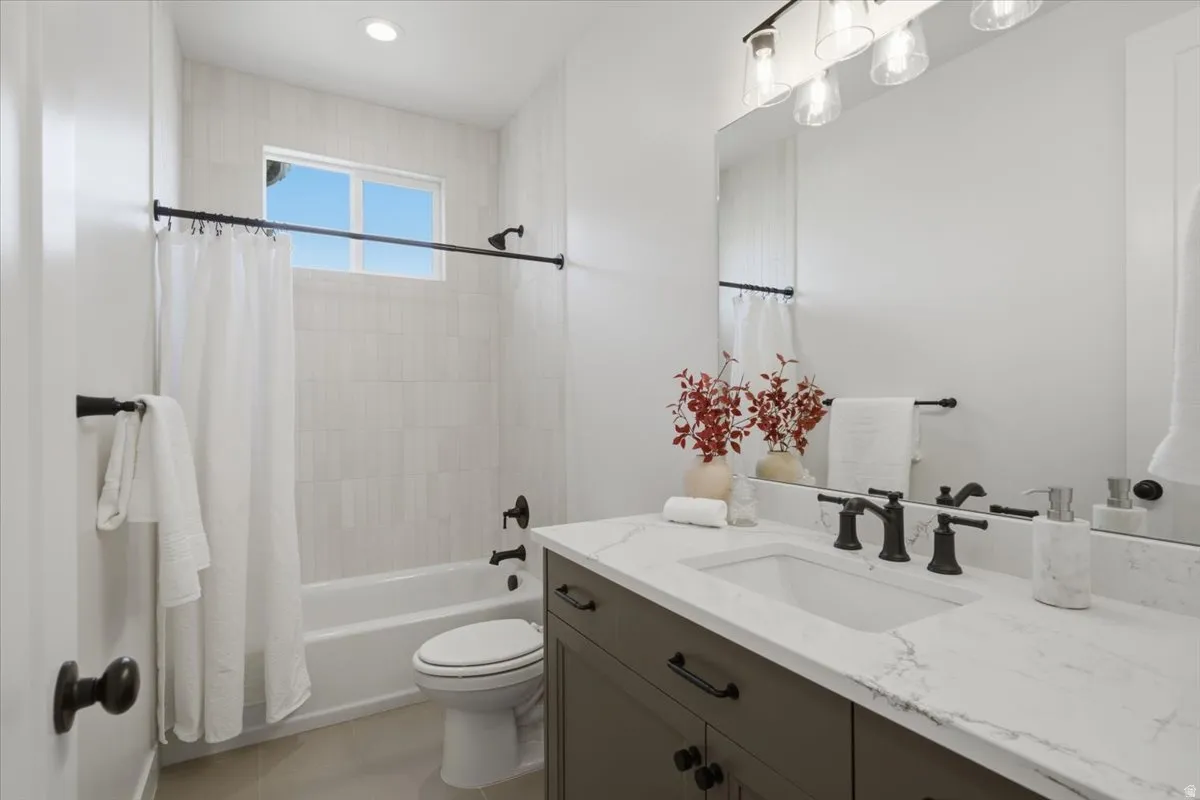 Contemporary vanity with white countertop, undermount sink, and matte black fixtures