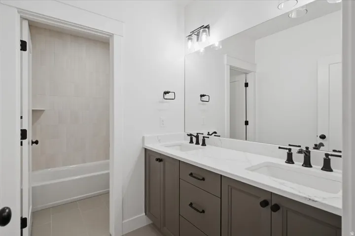 Dual vanity with white countertop, undermount sinks, and matte black fixtures