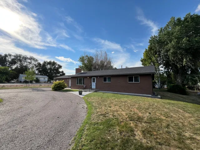 Brick ranch home situated on expansive grounds with mature landscaping and established trees