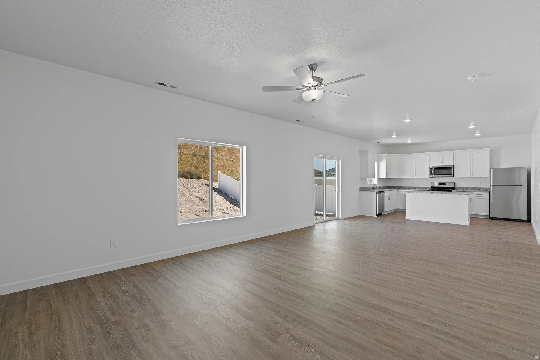 Open concept living area with wood-finish flooring