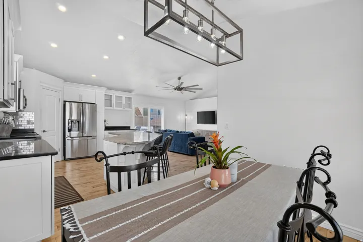 Kitchen featuring white cabinetry, black countertops, and stainless steel appliances