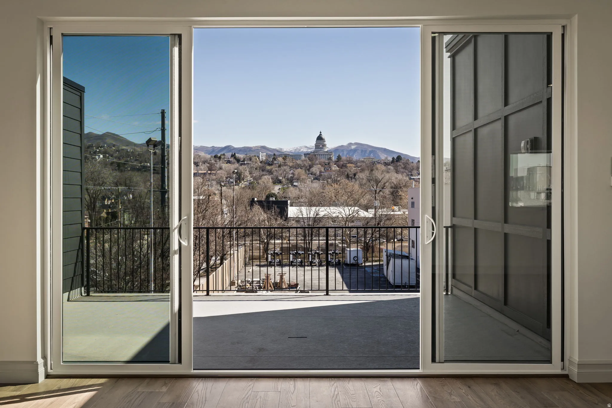Sliding glass door opening to an outdoor patio with black metal railings