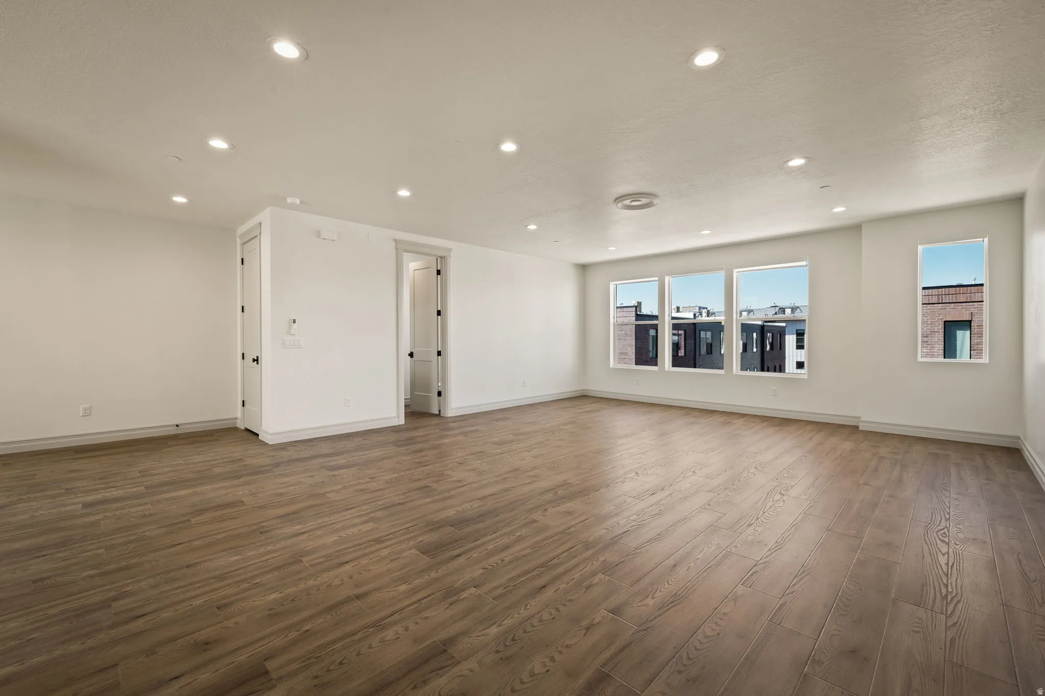 Spacious open floor plan with abundant natural light from oversized windows and glass doors