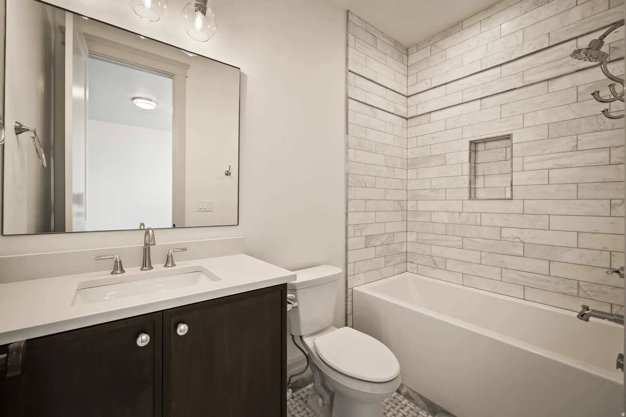 Vanity with an integrated sink, brushed nickel faucet, and a large rectangular mirror